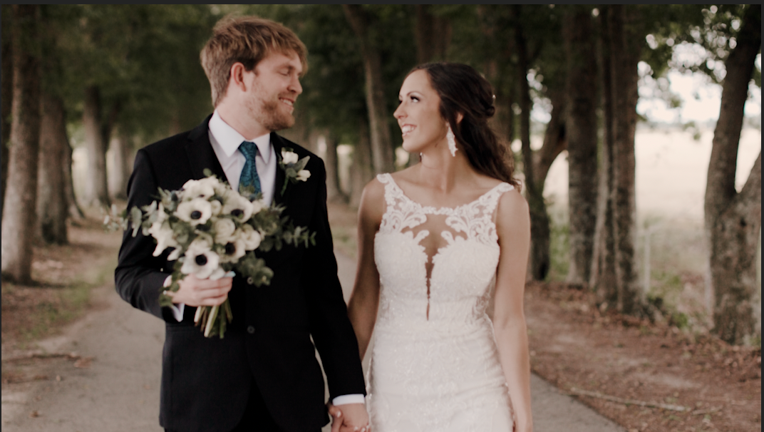 Romantic woodland wedding portrait with towering trees creating a natural backdrop.