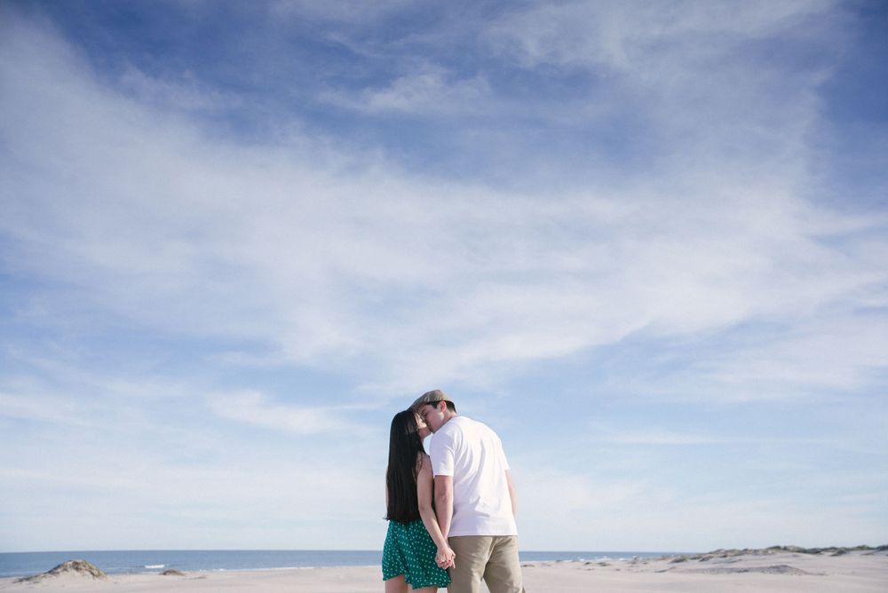 couple kissing. blue sky. beach photos. south padre island. wedding photographer