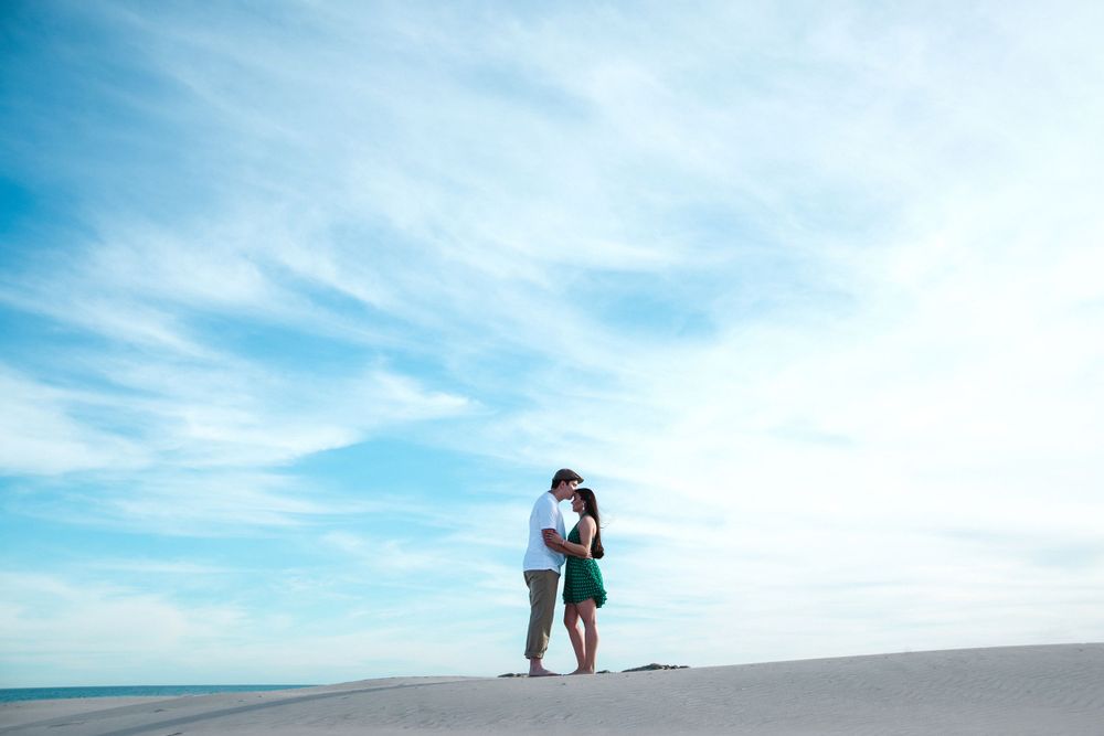 engagement couple session. blue sky. kiss. south padre island. wedding photographer