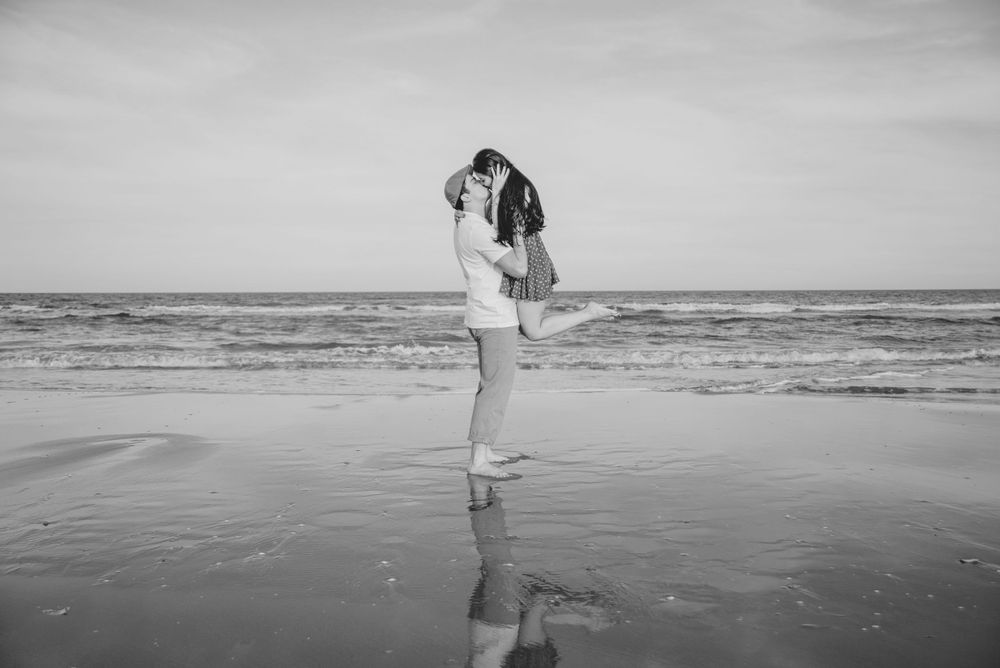 man lifting a woman. beach. sea. black and white. south padre island. wedding photographer