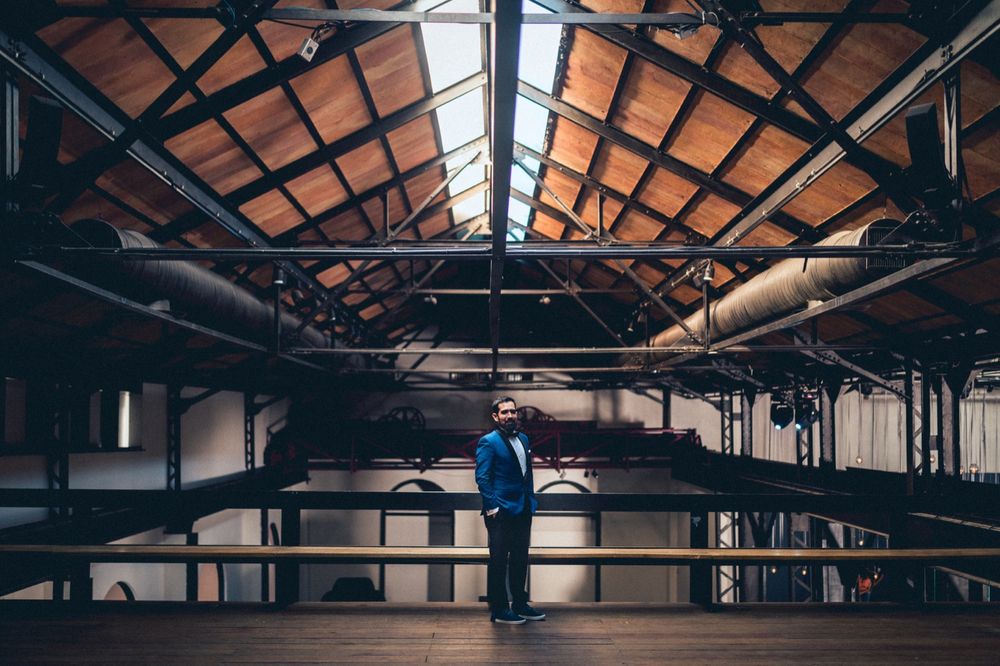 Industrial warehouse interior with exposed beams and dramatic lighting creating architectural ambiance.