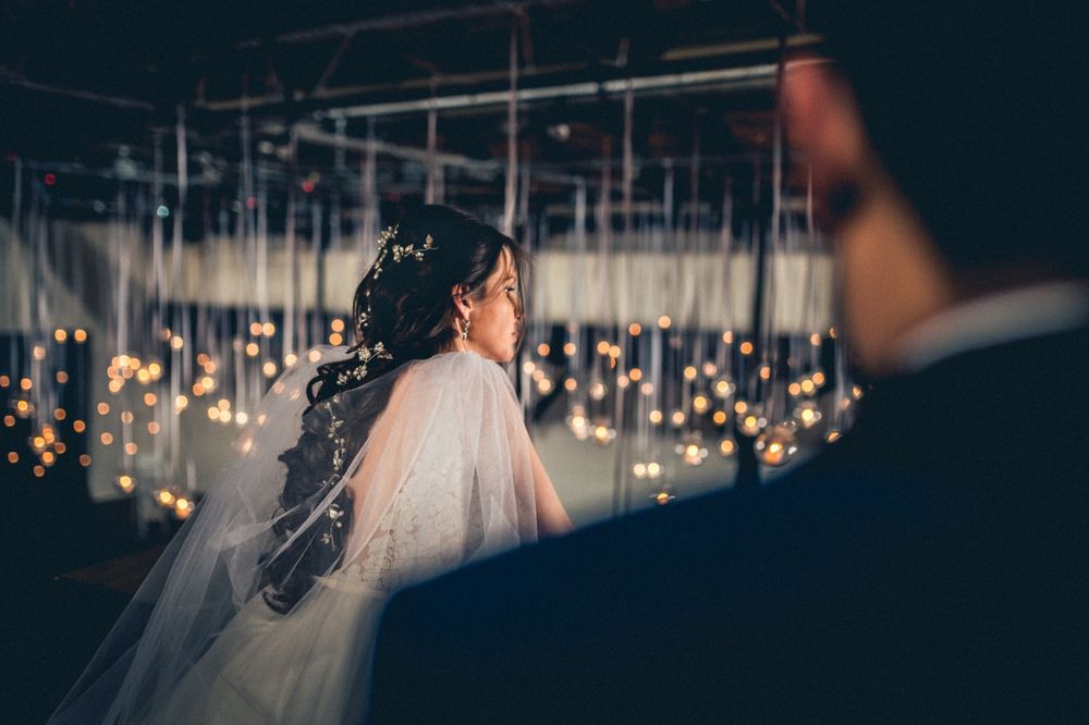 Wedding venue interior with hanging string lights creating a romantic atmosphere.