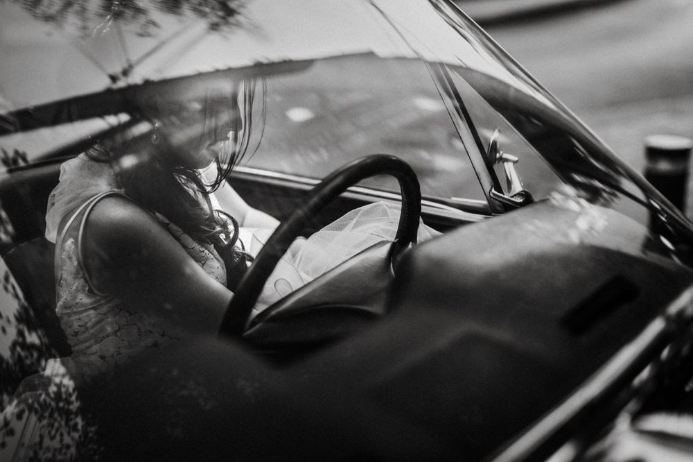 Artistic black and white shot through car windshield on wedding day.