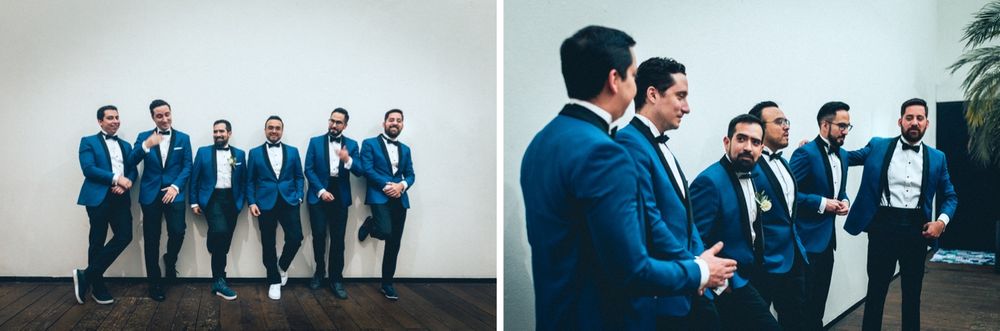 Groomsmen in blue suits sharing laughs during wedding photo session.