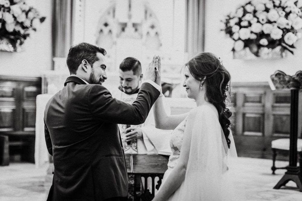 Elegant wedding ceremony moments in a grand hall with ornate details.