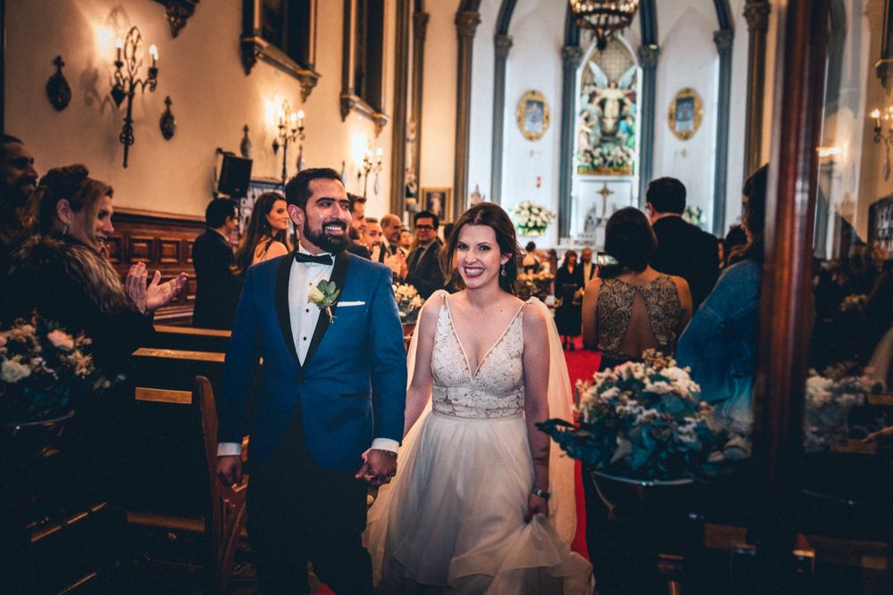 Wedding celebration in an ornate venue with warm lighting and architectural details.