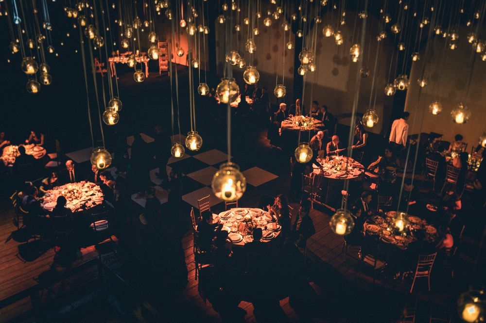 An atmospheric restaurant interior with multiple pendant lights creating ambient illumination.