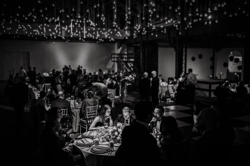 A dimly lit event space with scattered lighting creating a dramatic atmosphere.