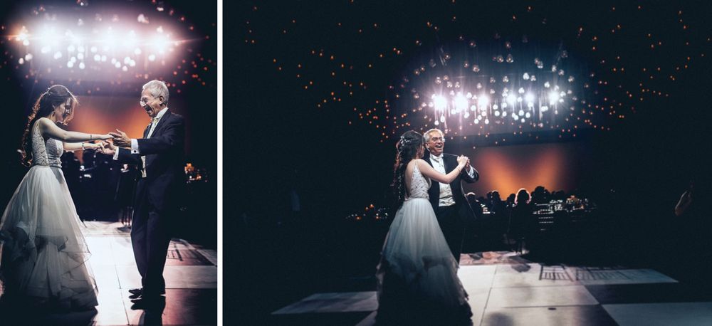 Couple sharing their first dance as newlyweds under dramatic lighting at wedding reception.