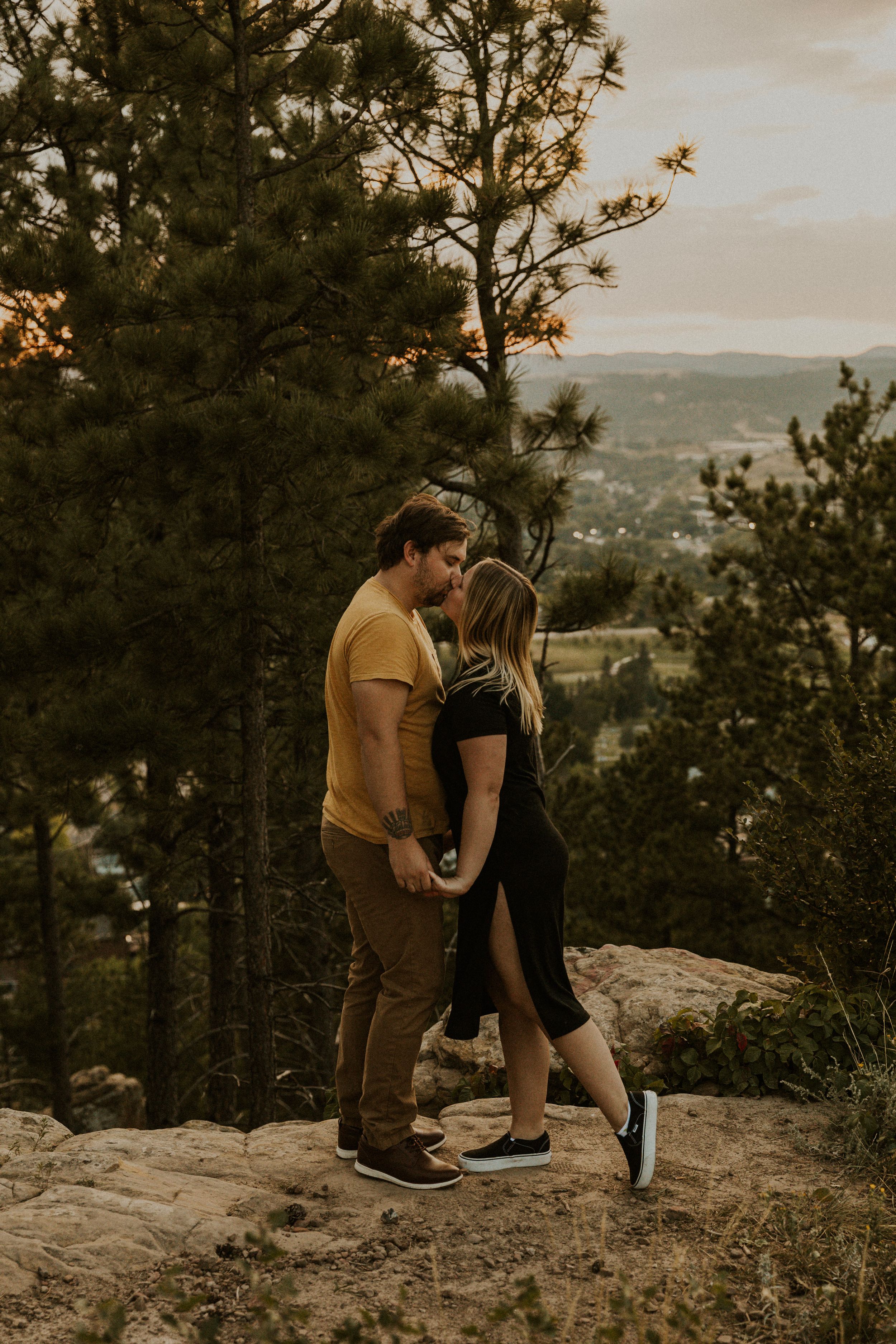 Sunset couple session in Rapid City, South Dakota. Couple shares kiss.