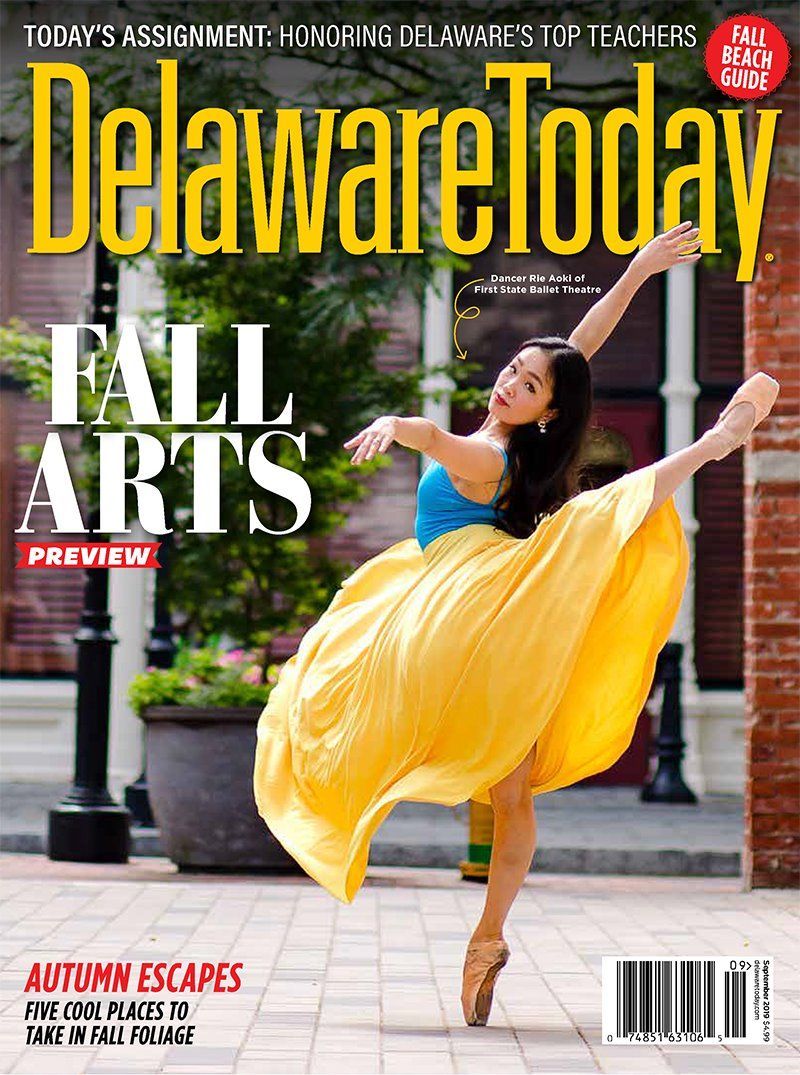 Delaware Today magazine cover featuring a ballet dancer in a flowing yellow dress performing outdoors.