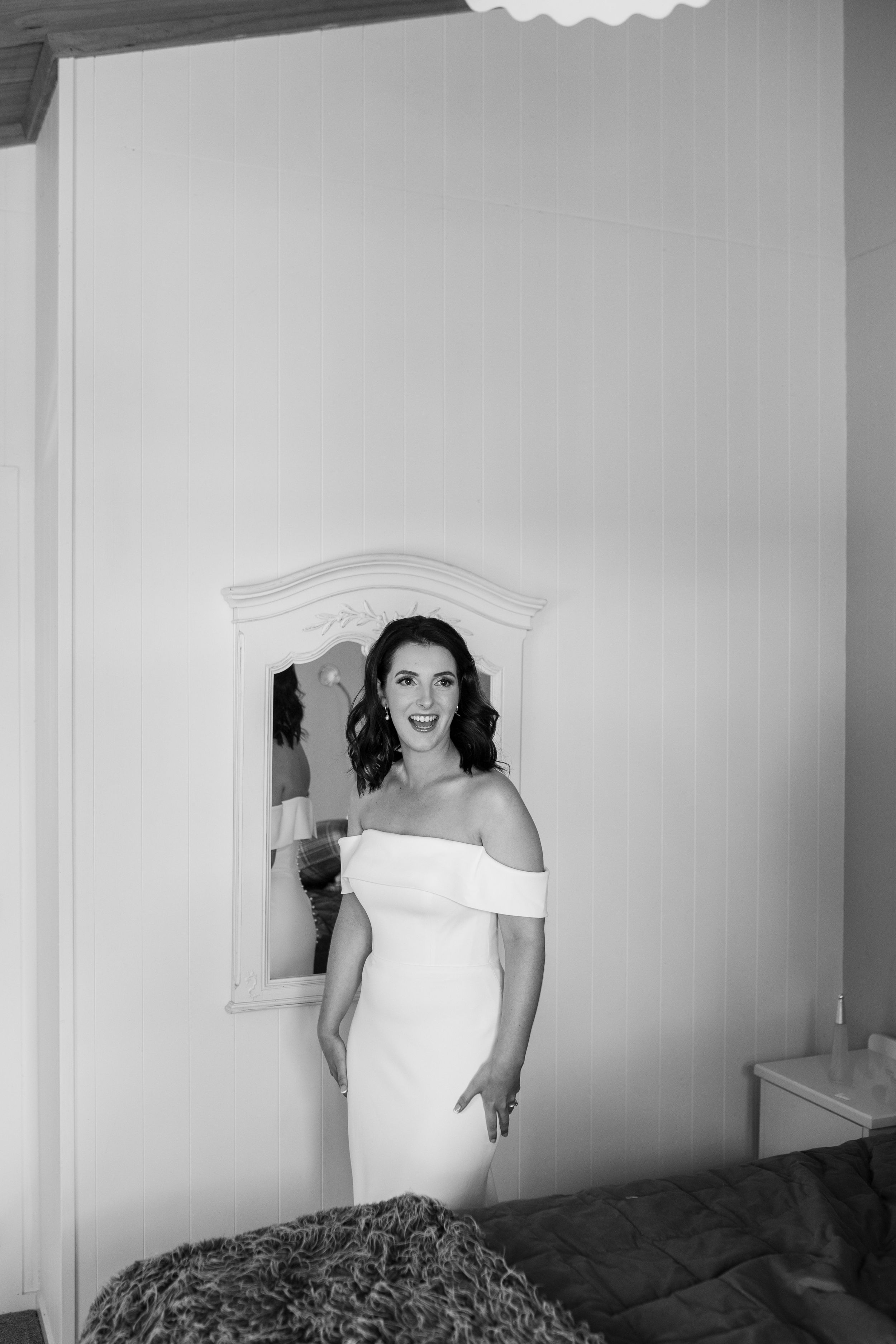 Classic black and white portrait with ornate mirror.
