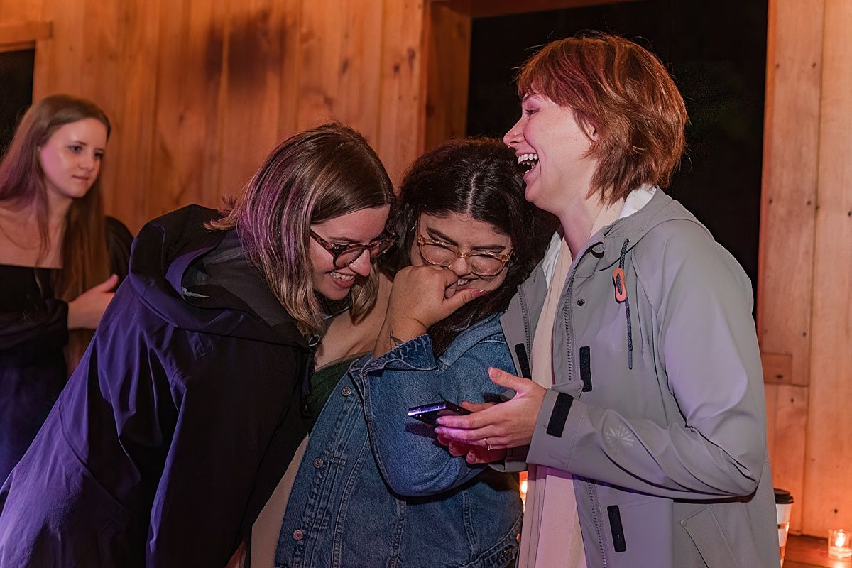 Photograph of guests laughing at wedding reception