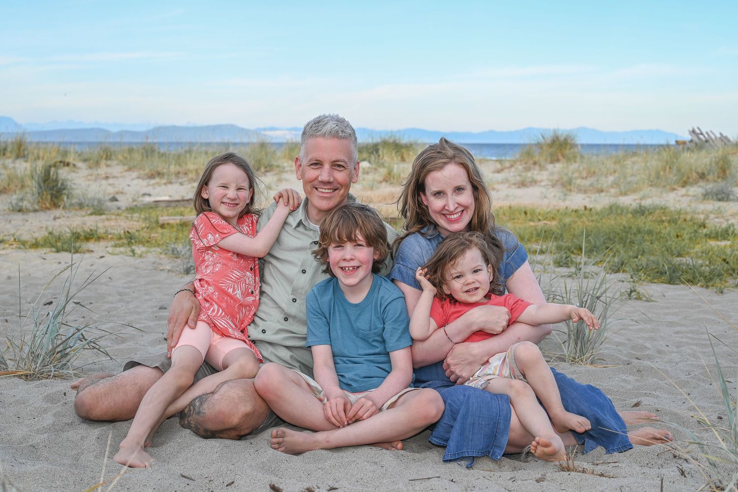 Family with 3 kids at the beach.