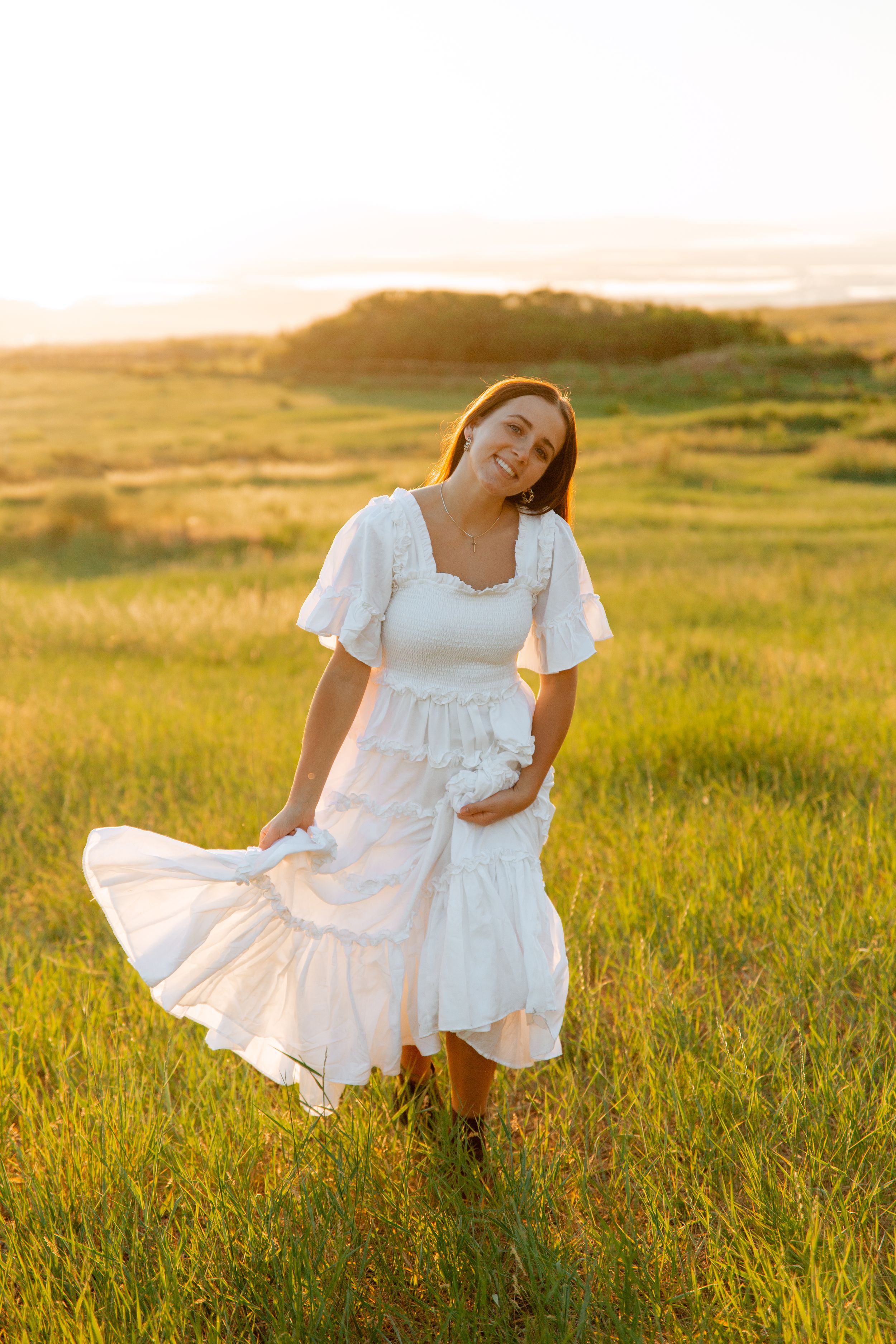 Senior portrait session in a white dress at tunnel springs park utah
