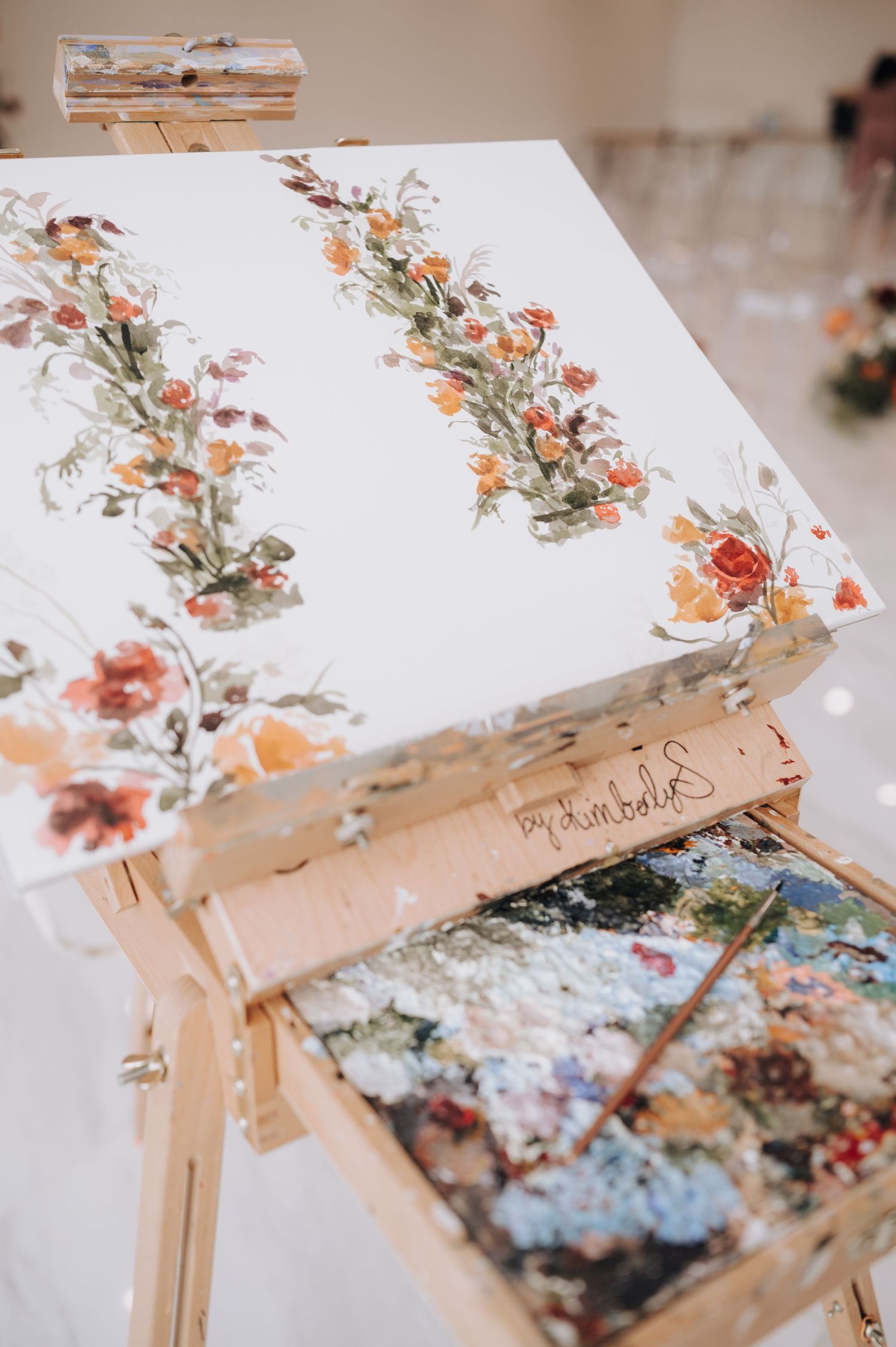 Floral wedding invitation or guestbook with delicate orange and pink flower pattern and silk ribbon.