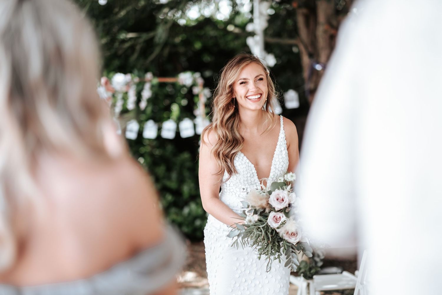 Bridge in white dress smiling
