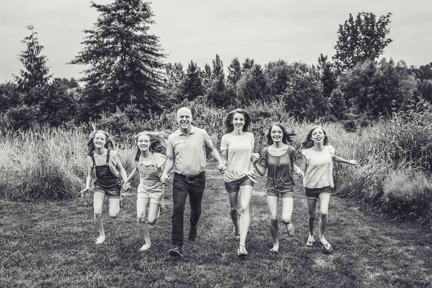 Family running towards photographer in Tolt McDonald Park