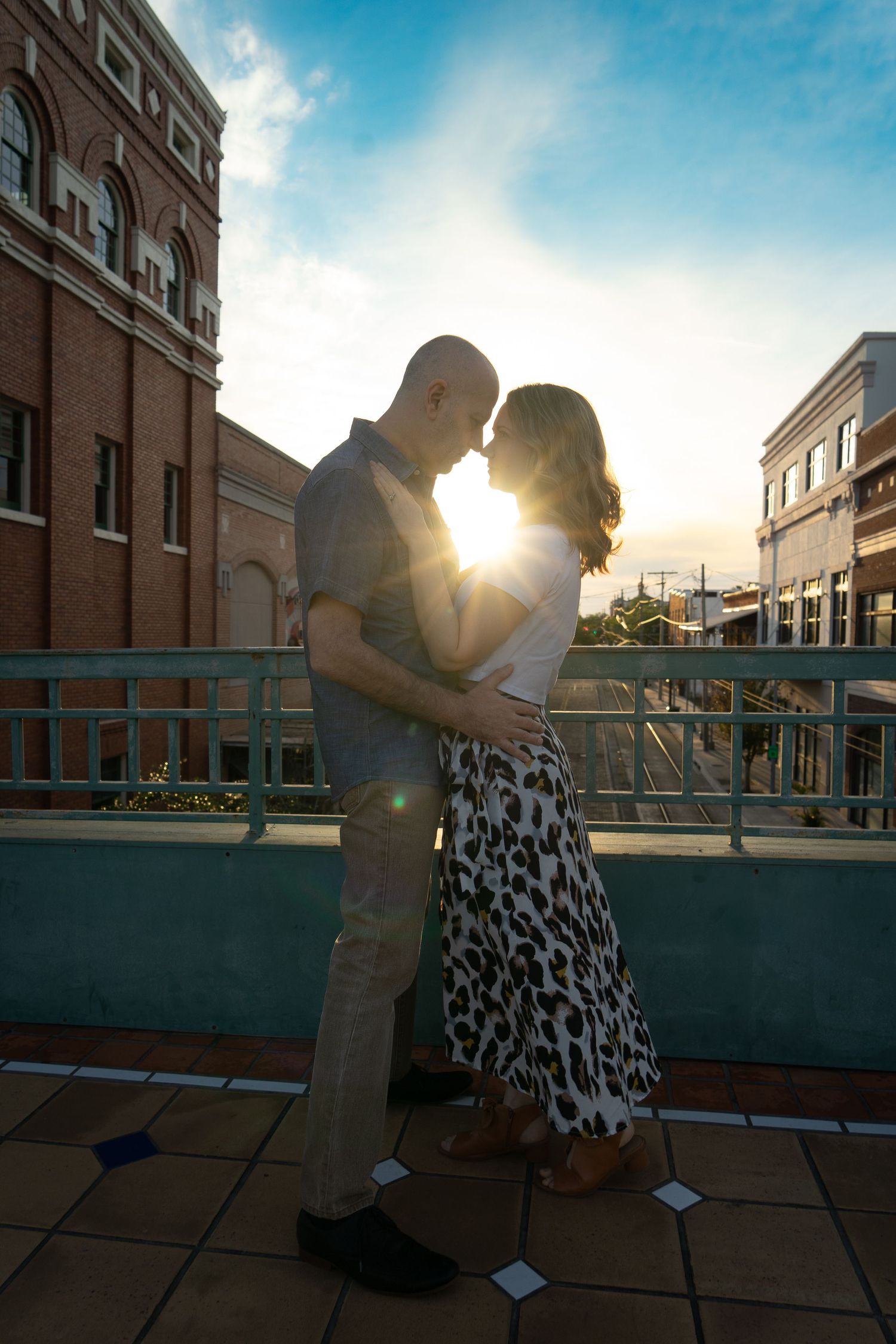 Sunset rooftop photoshoot with urban architecture and dramatic lighting.