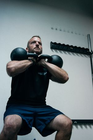 lifting kettle bells at gym