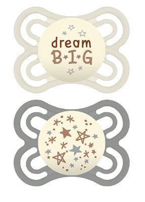 Two baby pacifiers with star designs and 'dream BIG' text in cream and gray colors.