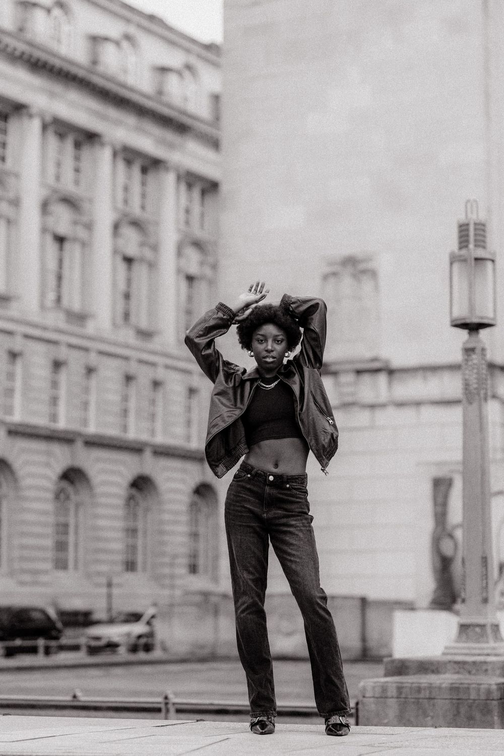 Black and white fashion series showing dynamic poses in front of classical architecture.