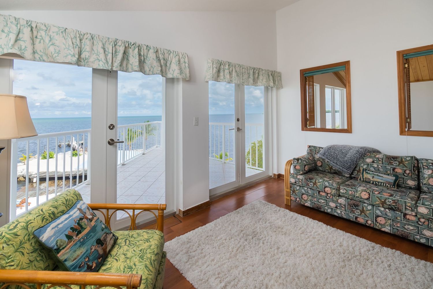 Coastal vacation home interior with panoramic ocean views through large windows.