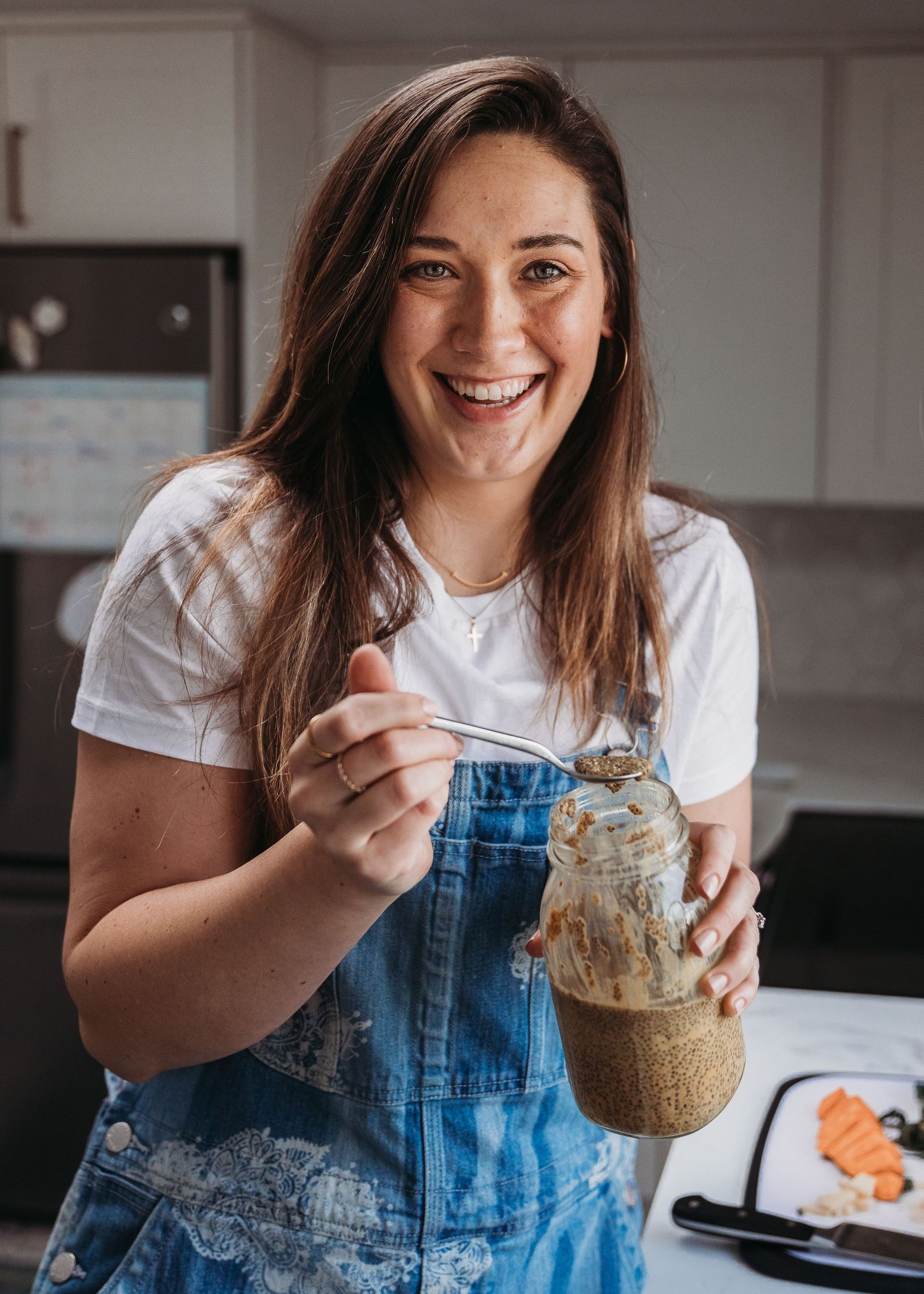 Kitchen scene with glass jar of smoothie and casual denim outfit.