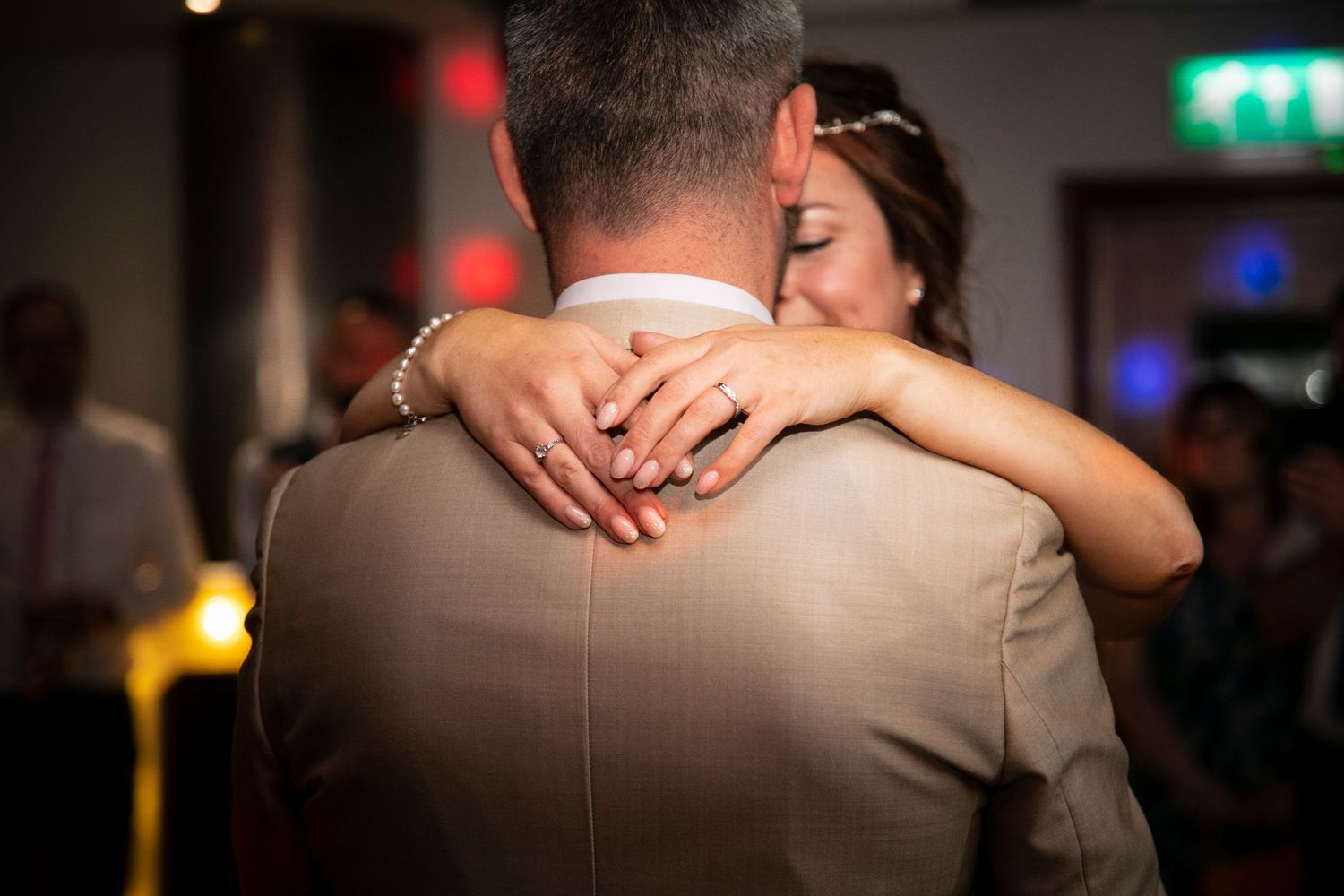 Close-up shots of couples embracing during romantic wedding dances.
