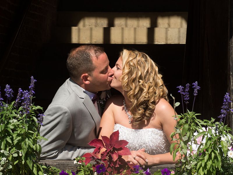 A balcony kiss overlooking a stunning garden, best secret wedding venues 2022 Oxfordshire.