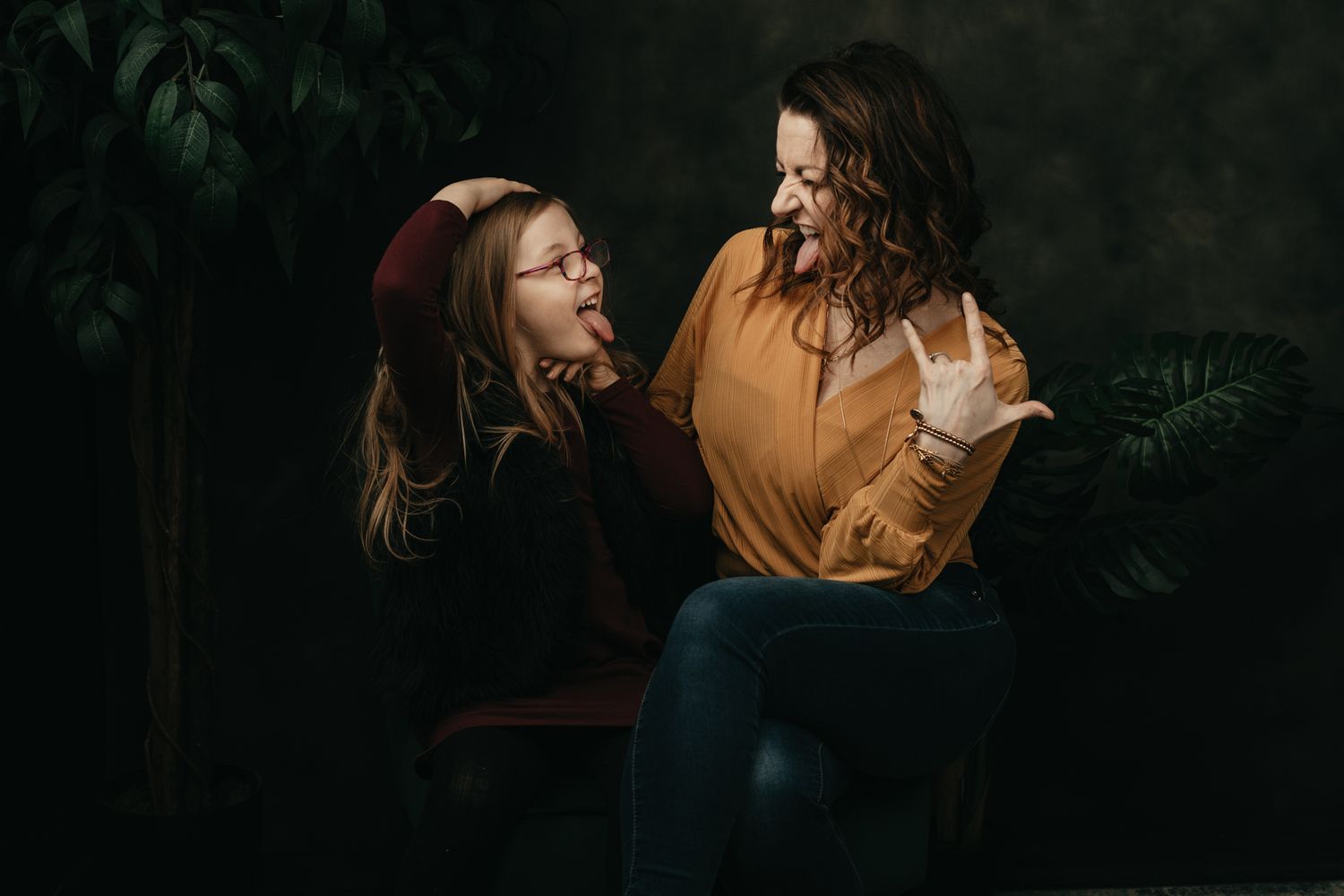 Cozy indoor portrait session with warm lighting and casual autumn attire.
