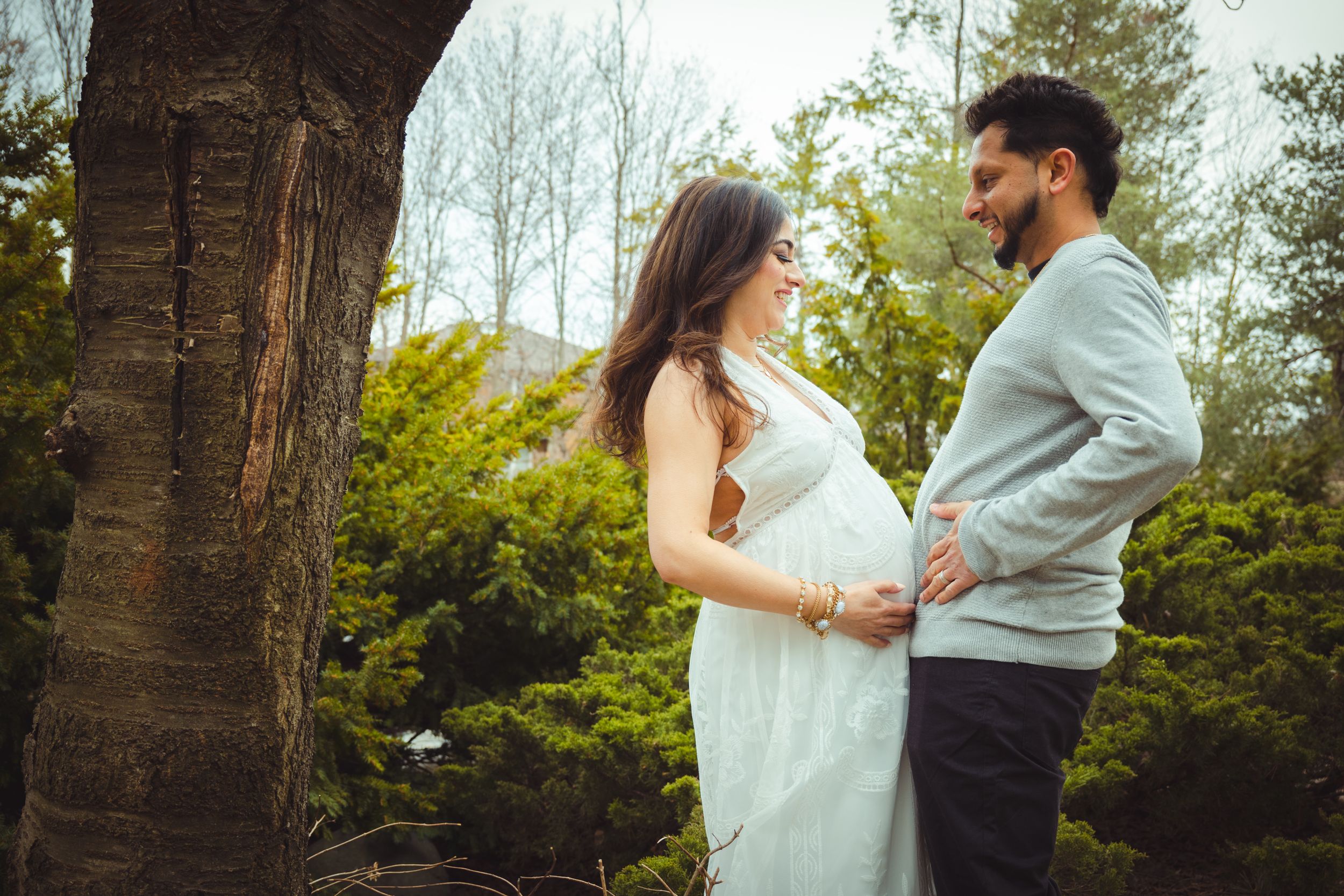 Romantic outdoor couple photography session with white dress and casual attire.
