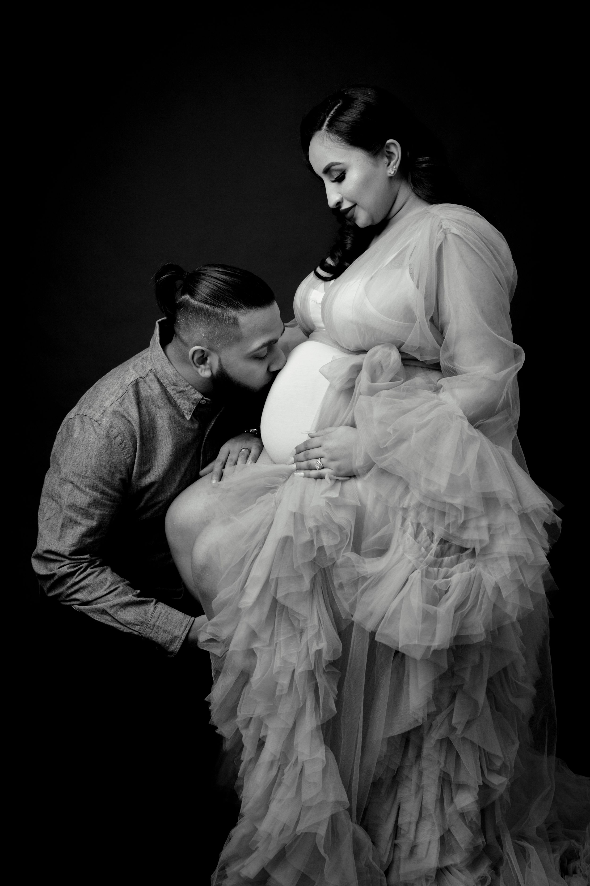 Romantic black and white maternity photos with flowing white tulle gown.