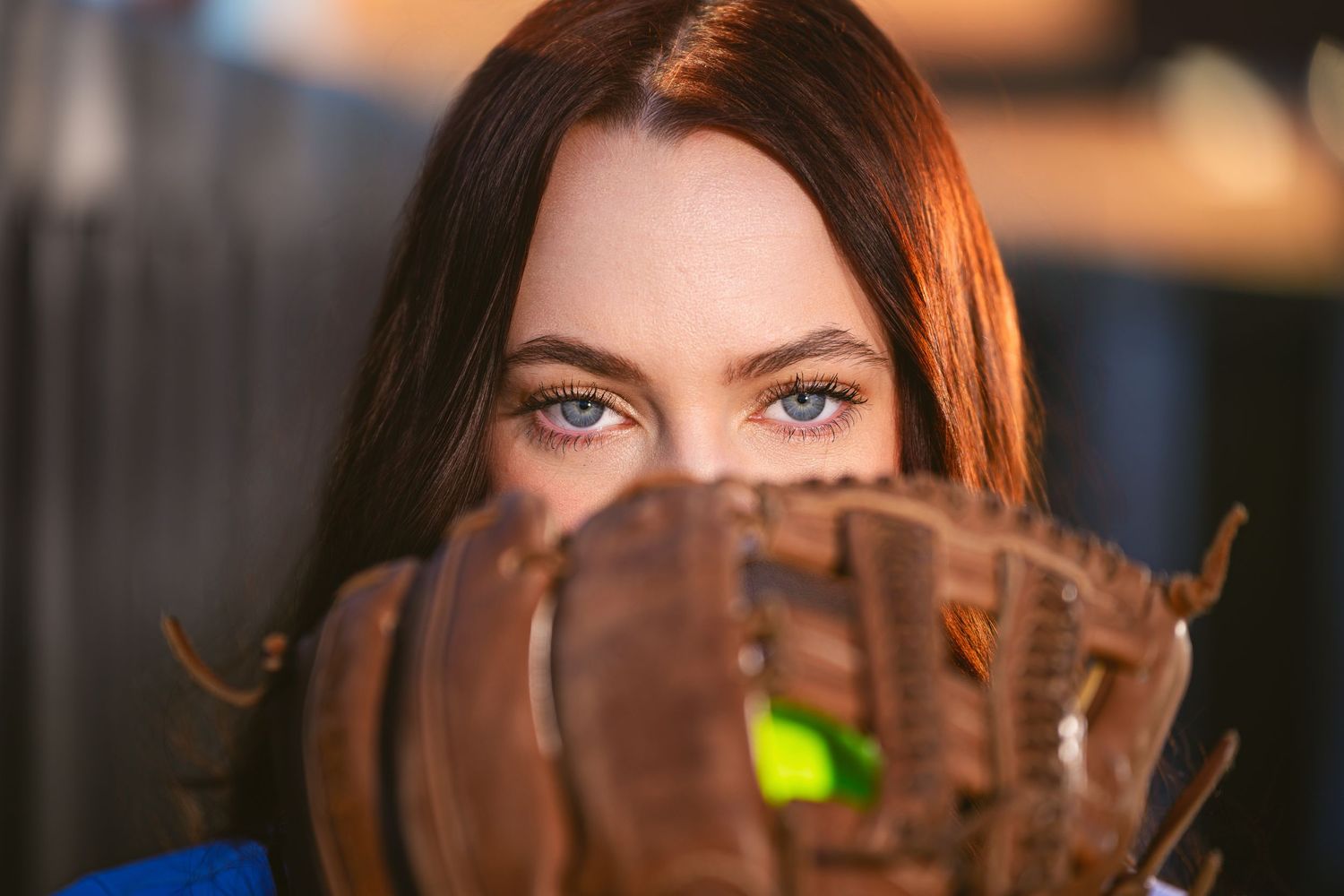 Close up sports portrait with baseball glove and dramatic lighting.