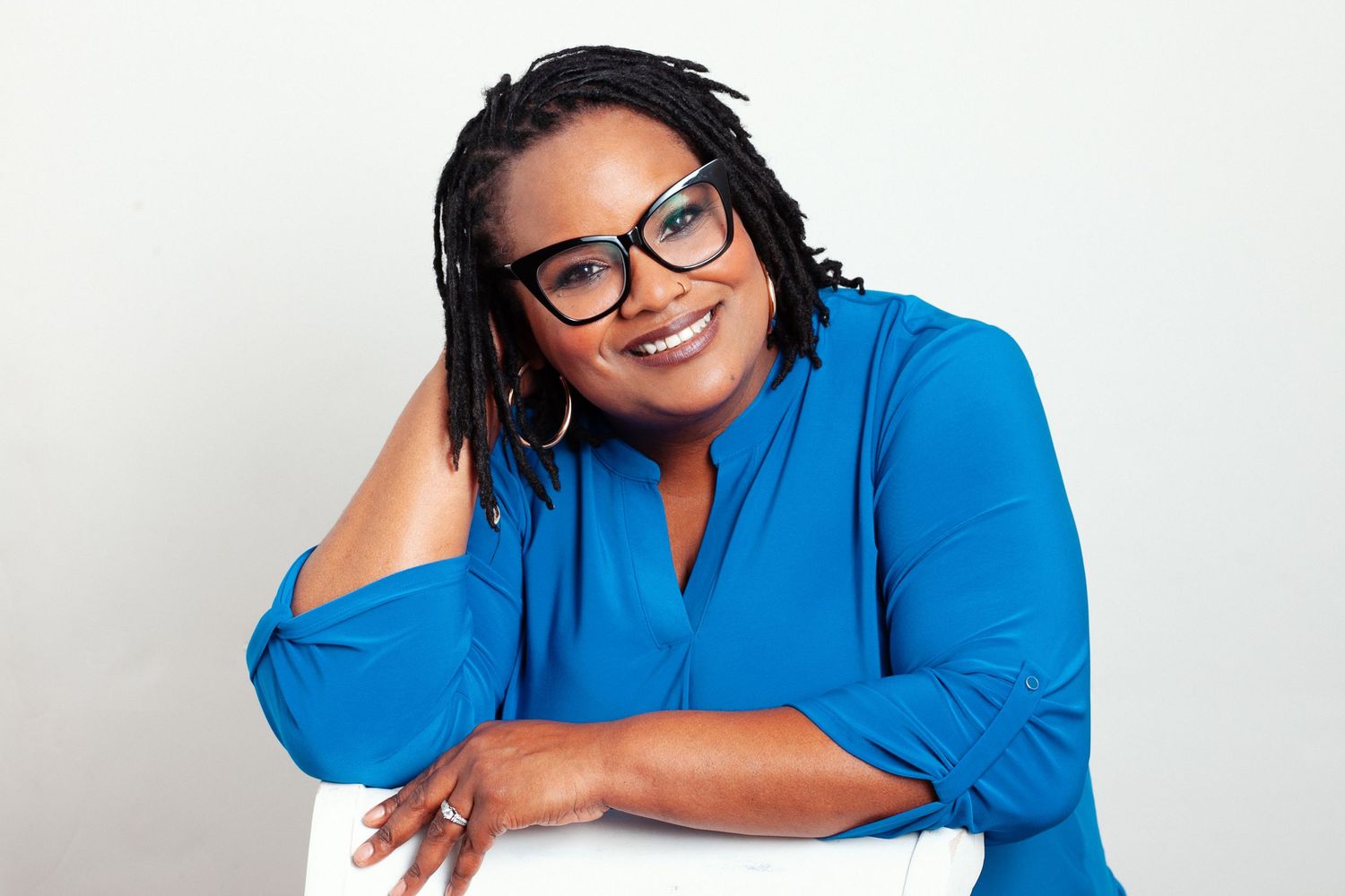 Dr. Joy's casual headshot in a blue shirt photographed in Norfolk, Virginia.