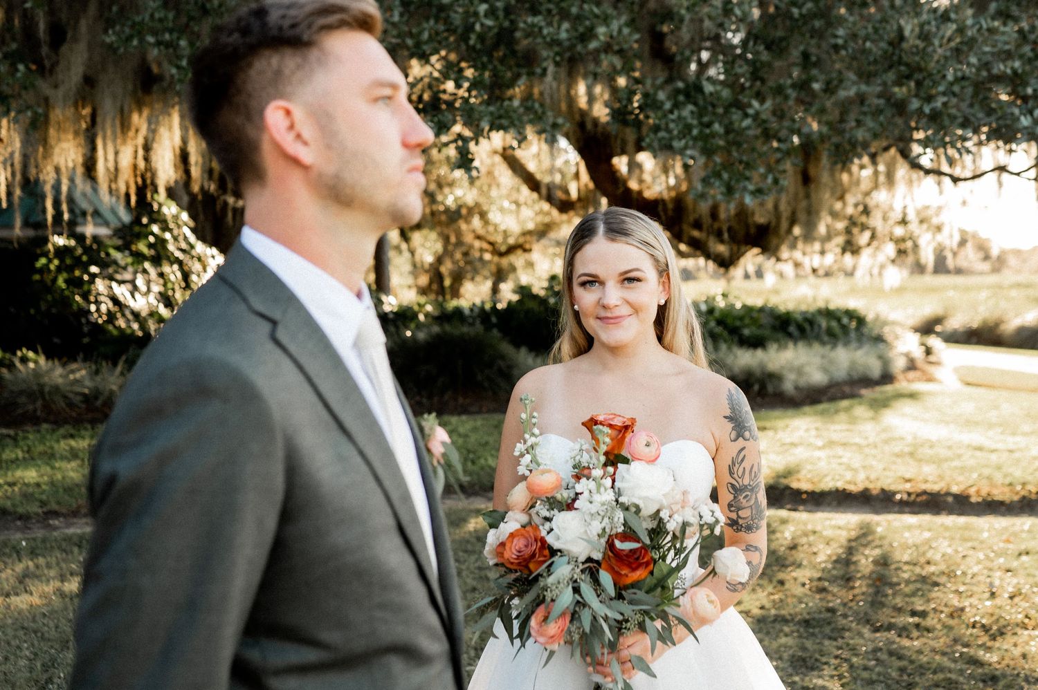 A couple shares tender moments during their sunset wedding photoshoot under moss-draped trees.
