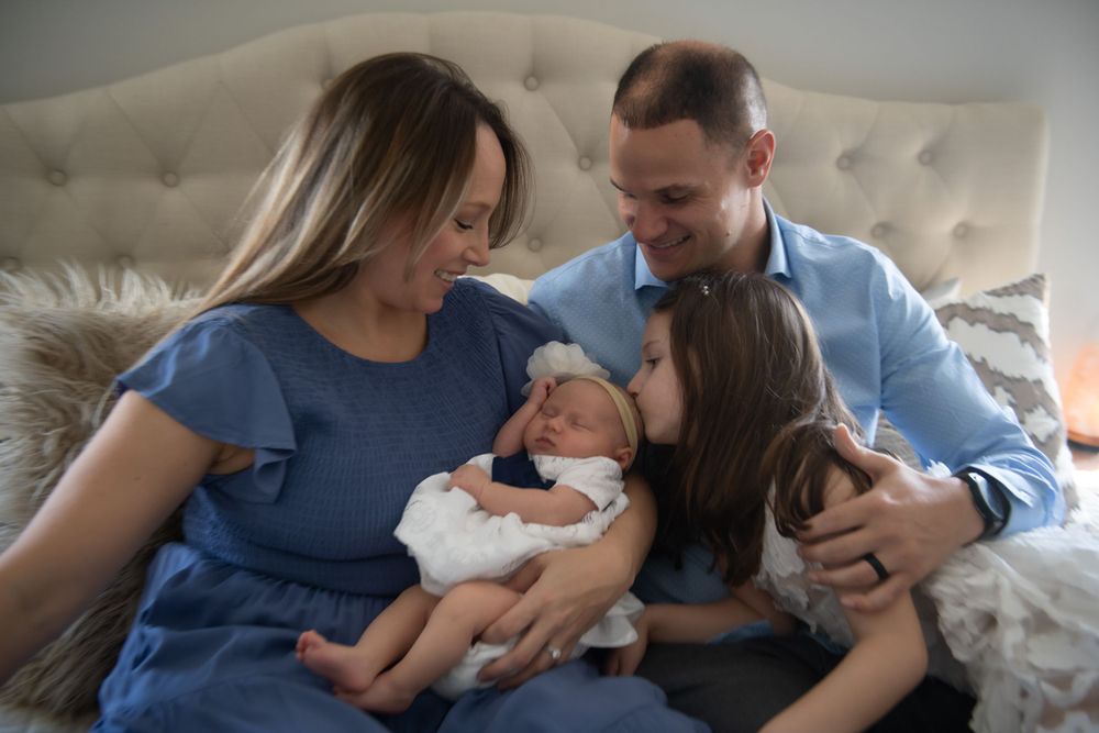 Candid family moments shared on a comfortable bed.