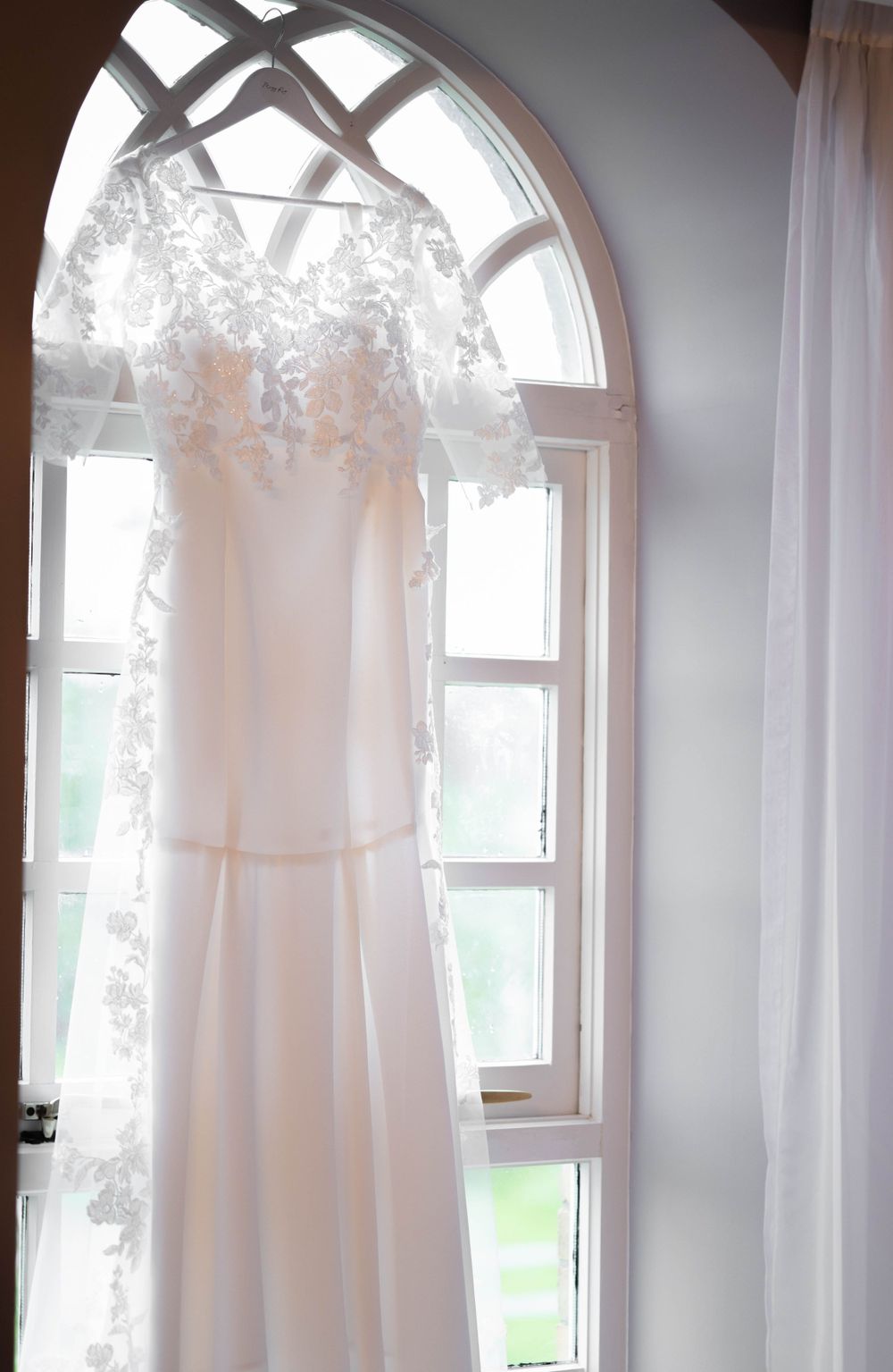 Wedding Dress hangs in window
