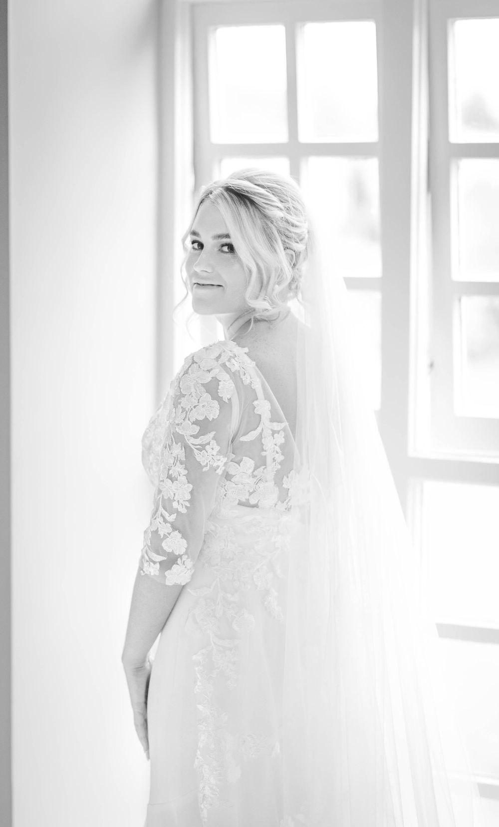 black and white image of bride looking over her shoulder
