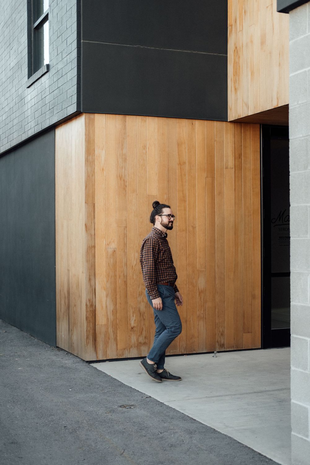 Modern interior with wooden panels and geometric black and white walls.