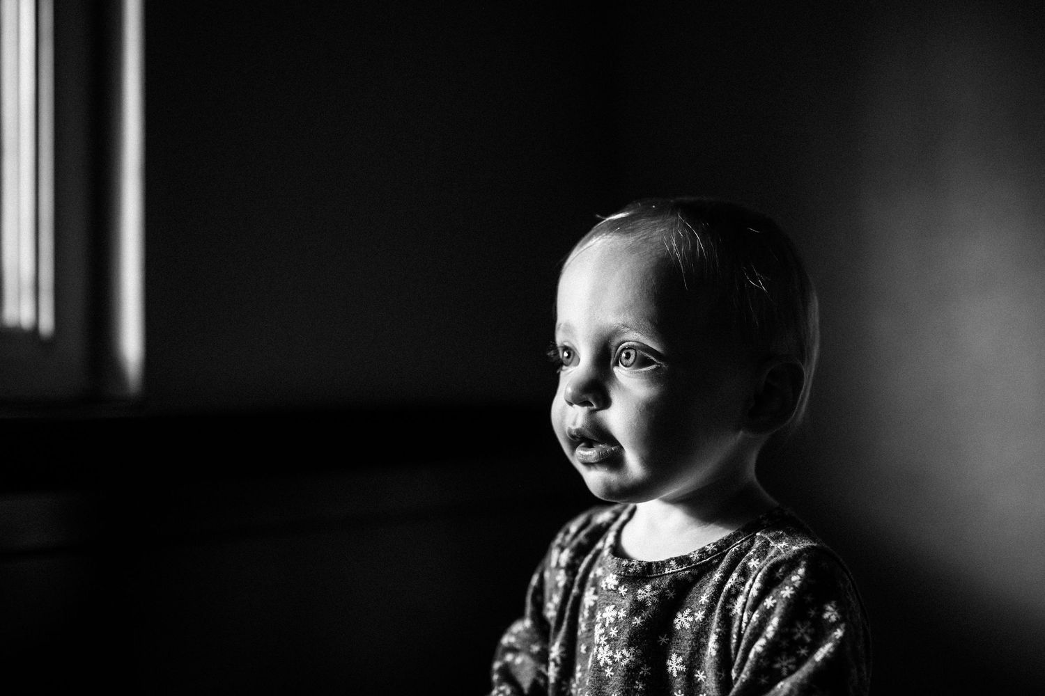 black and white portrait of toddler with dramatic lighting