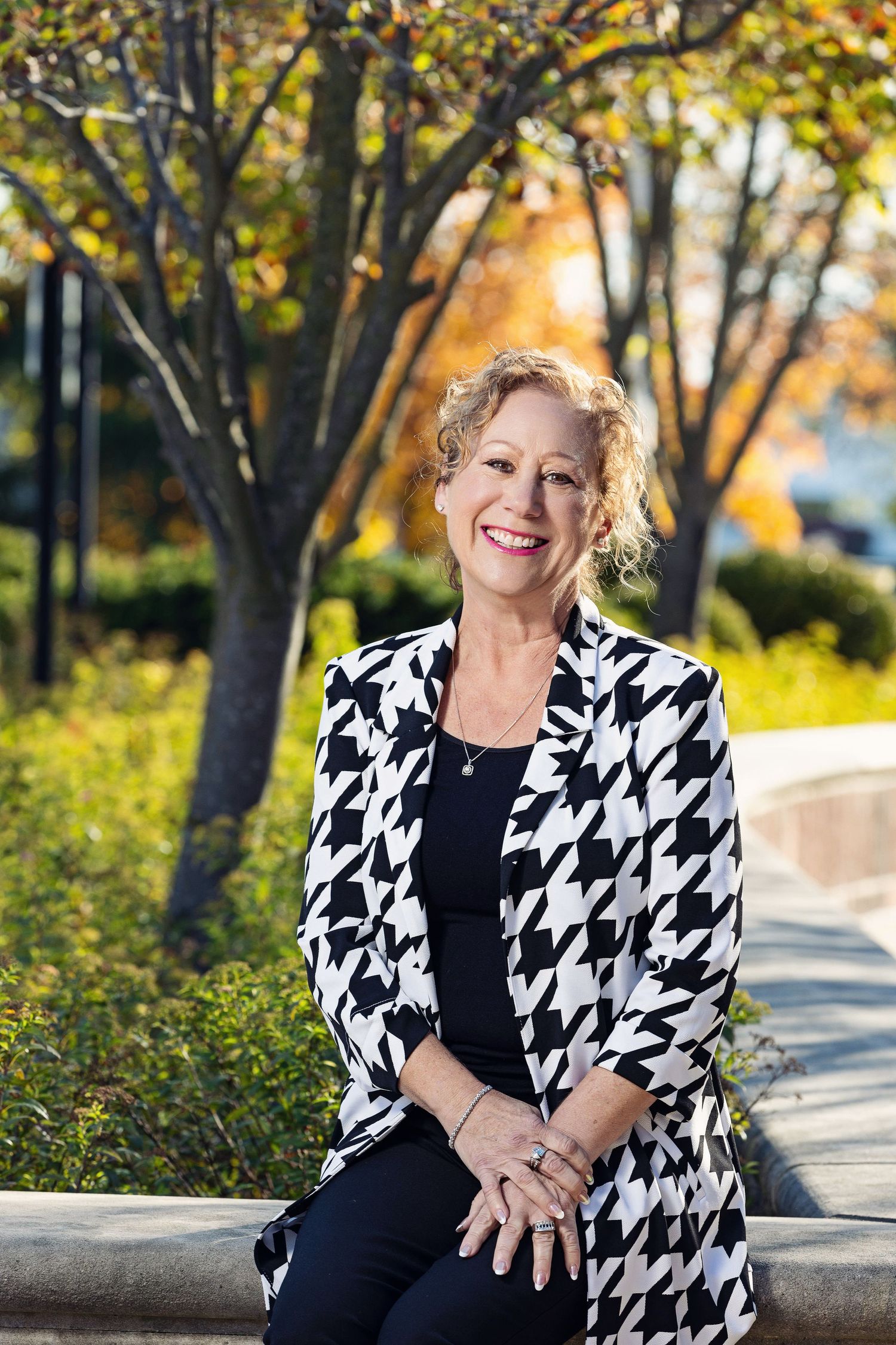 Outdoor portraits featuring someone in a black and white houndstooth jacket during autumn.