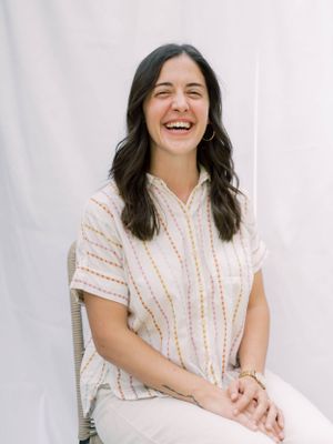 outdoor headshot of a girl sitting and laughing