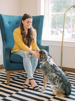 branding photo of a woman petting her dog