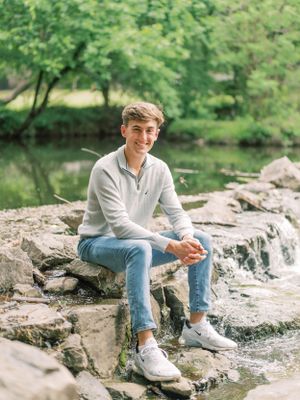 Senior sitting on rocks in Richardson, TX