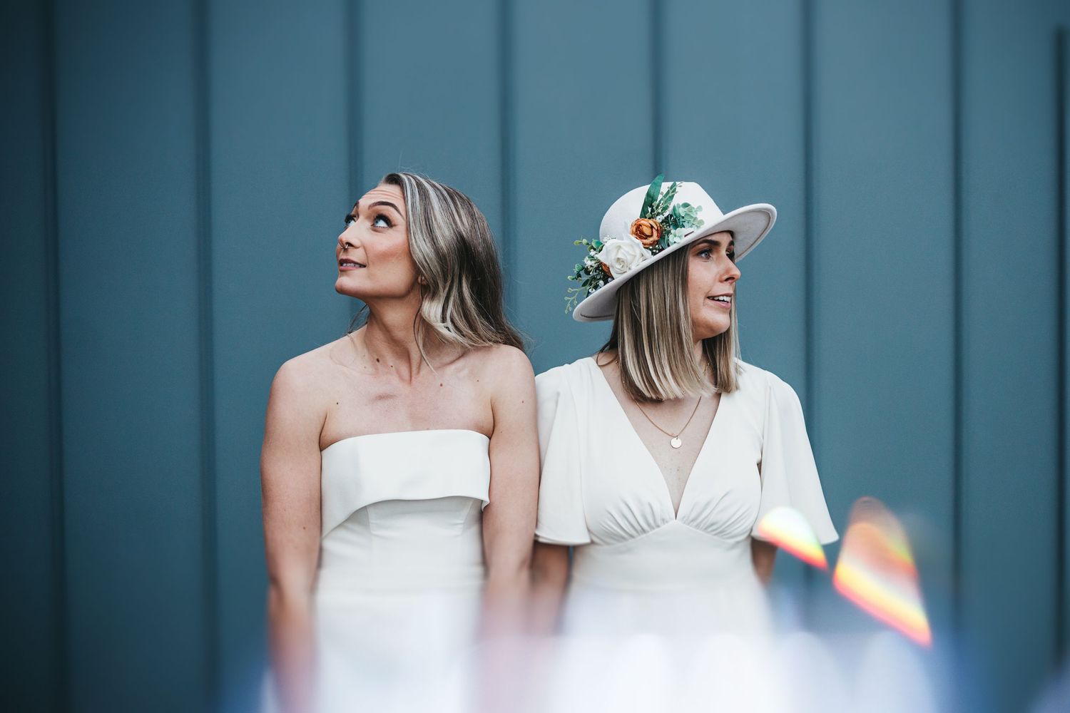 LGBT couple stood in front of light blue wall in Haarlem Mill
