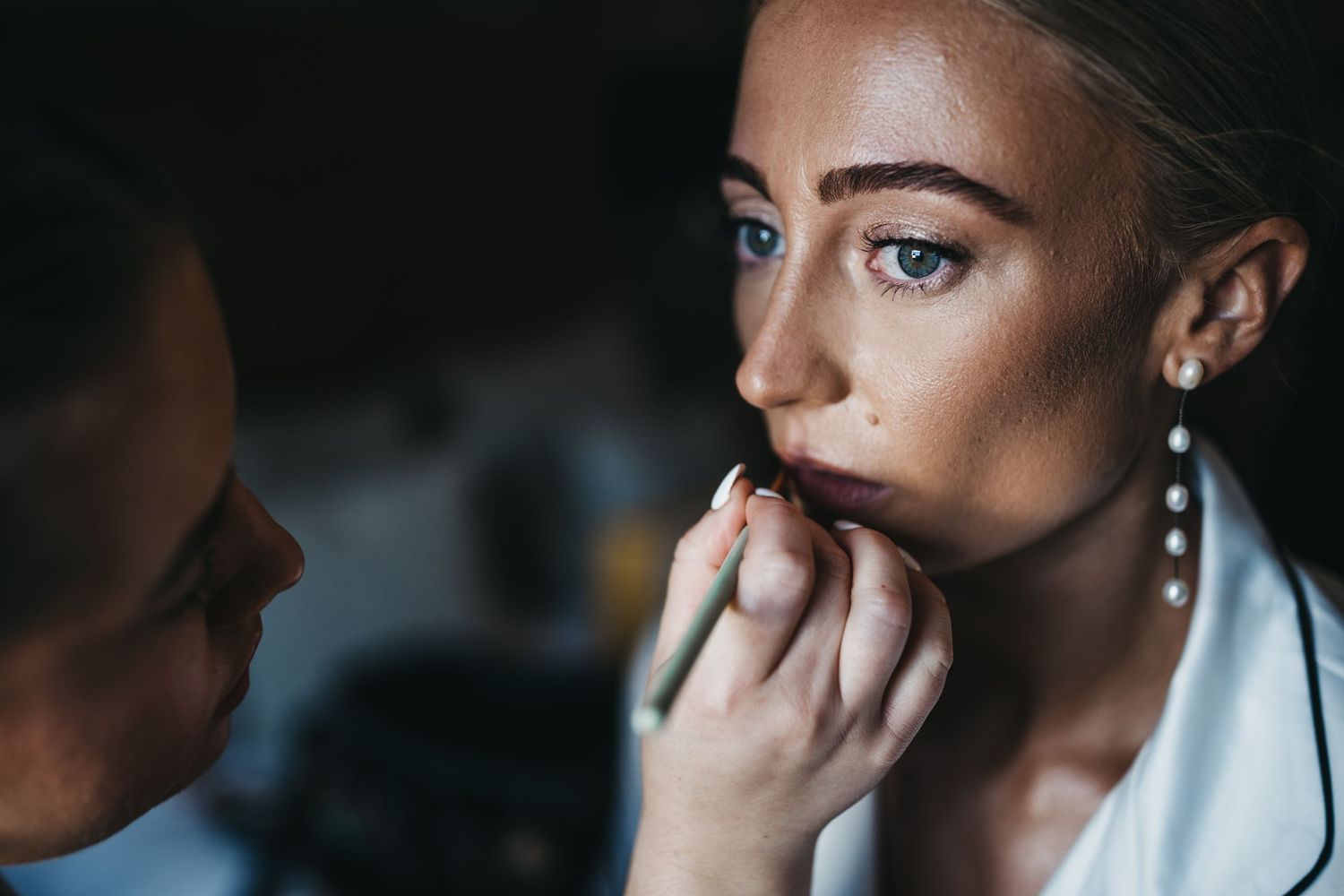 close up of Bride having her lipstick applied at Swancar Farm