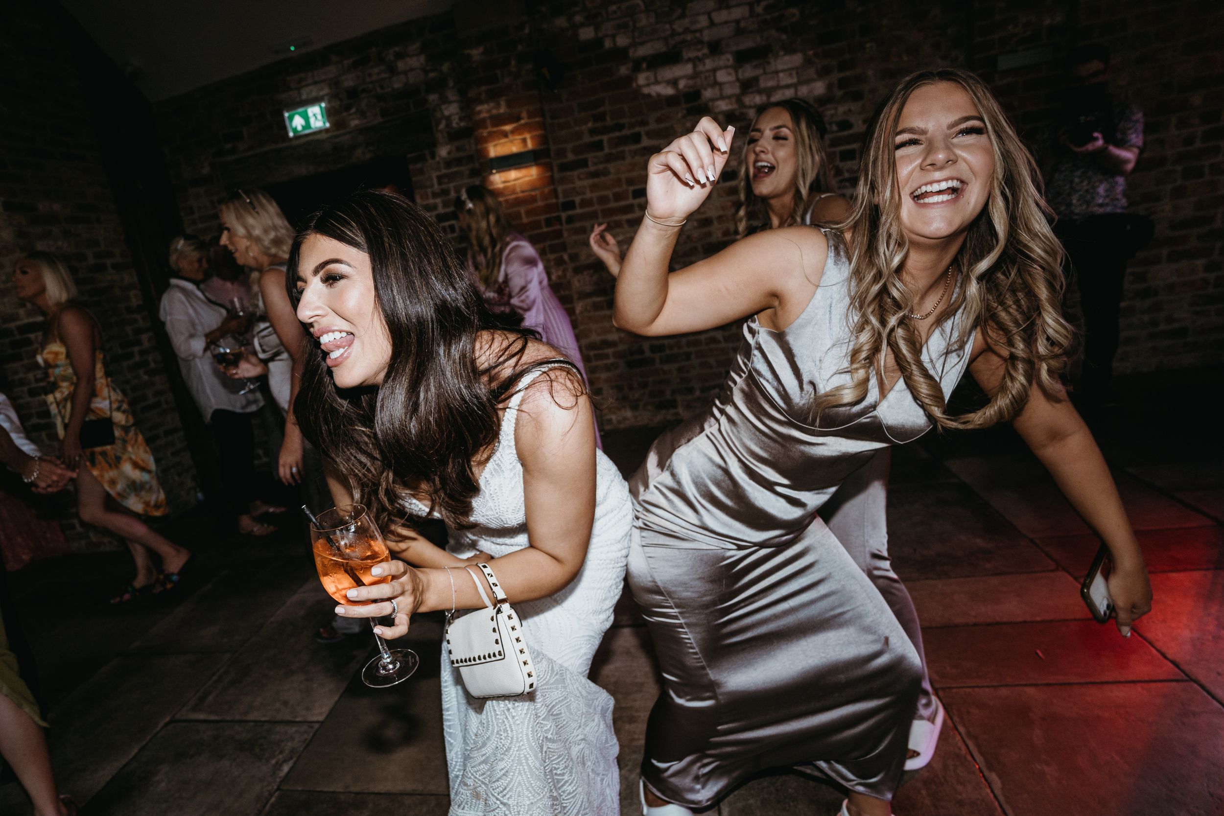 Bride and a bridesmaid dancing