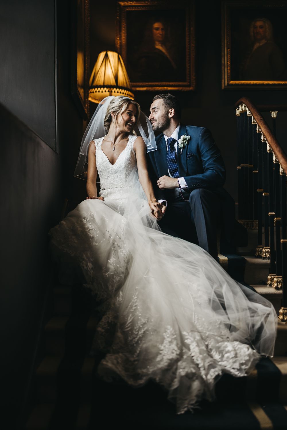 Bride and groom sat on stairs at Stubton Hall having a quiet moment