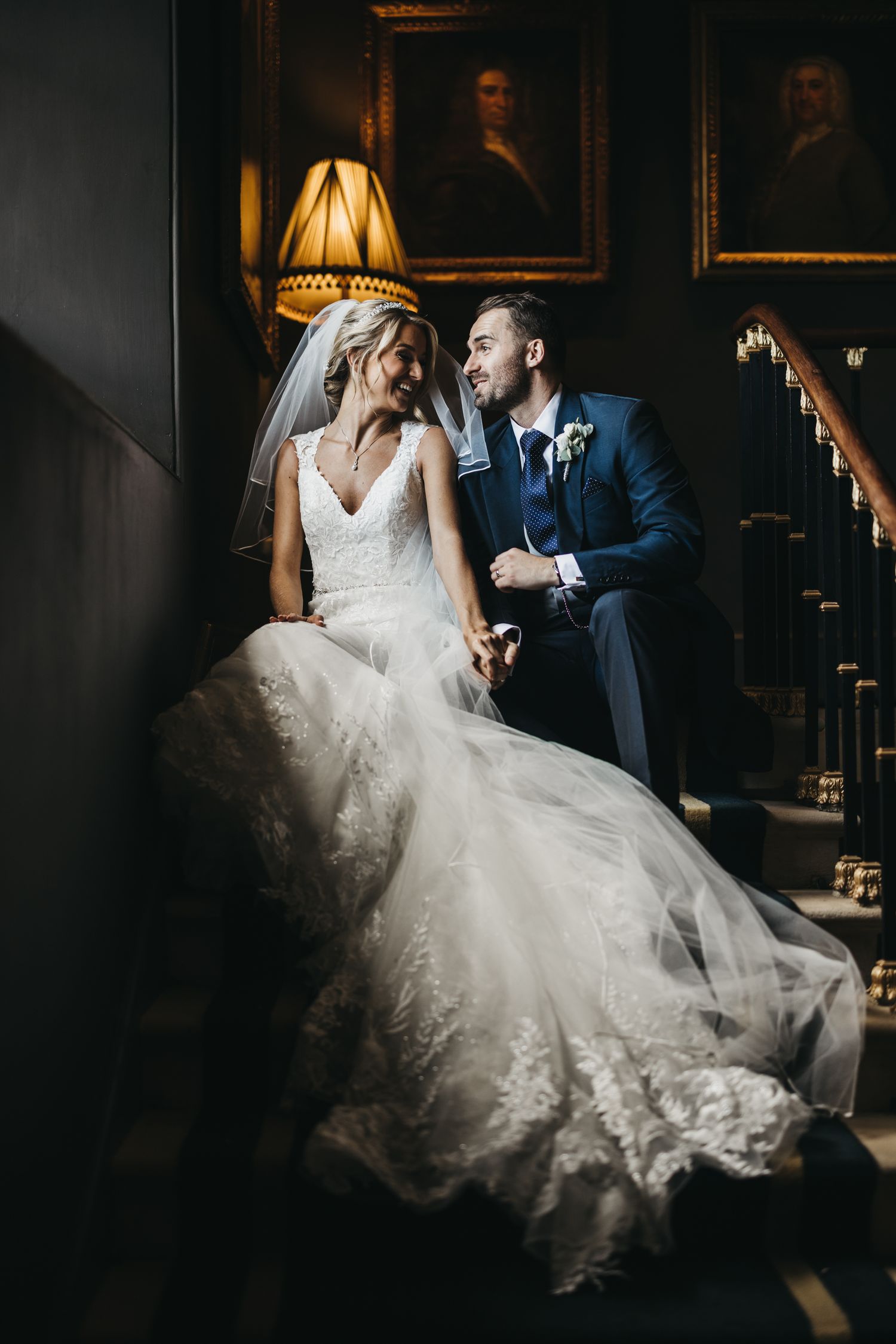 Bride and groom sat on stairs at Stubton Hall having a quiet moment